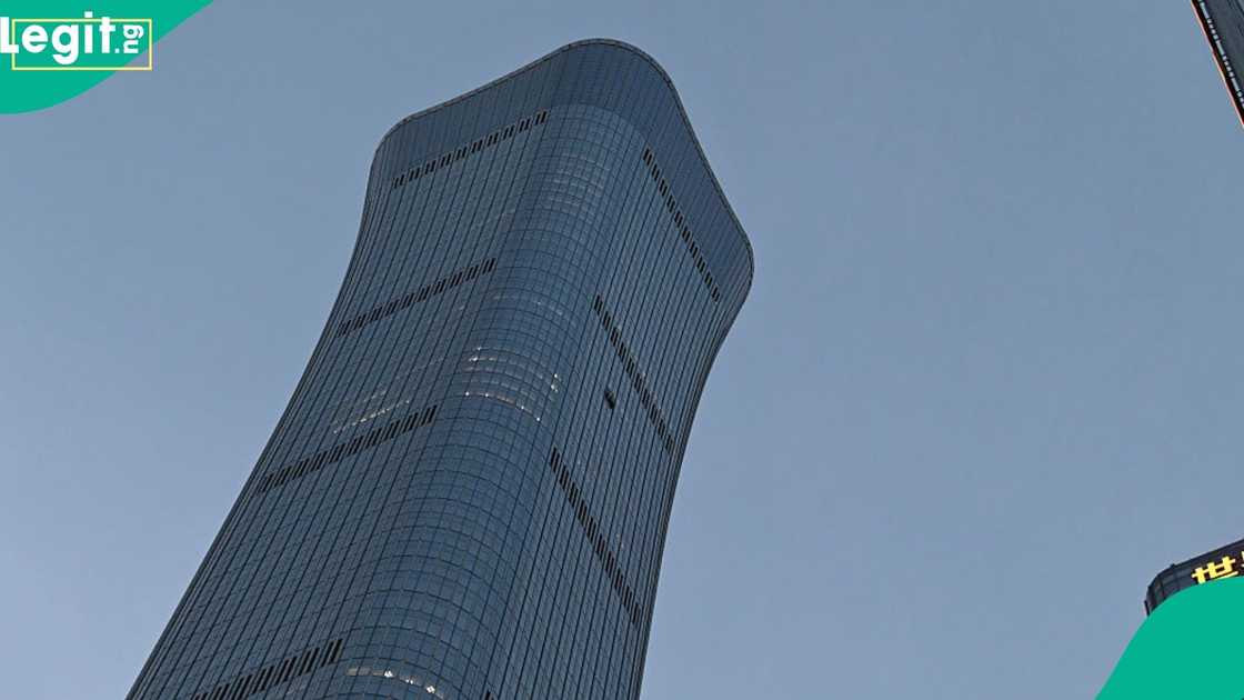 Small plane strikes CITIC Tower in Beijing as emergency services evacuate building.