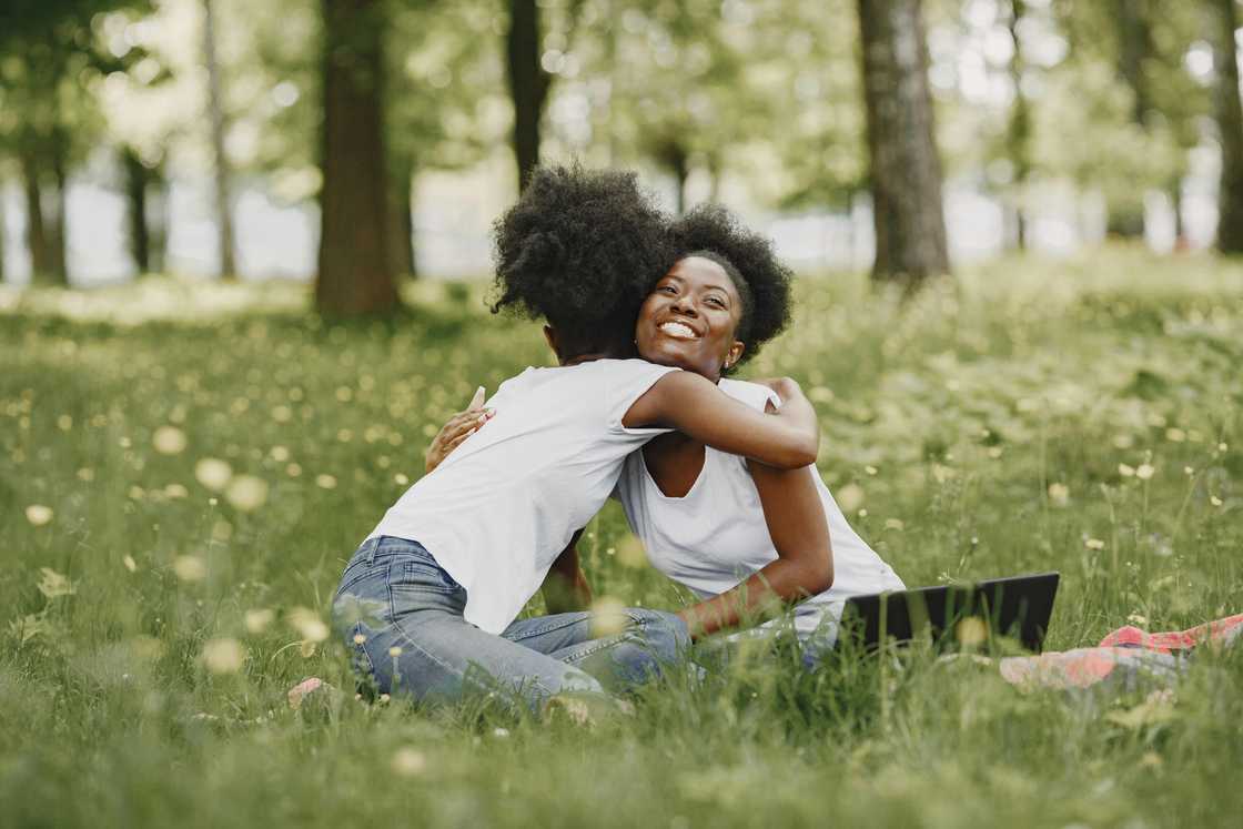 Two women sitting and hugging