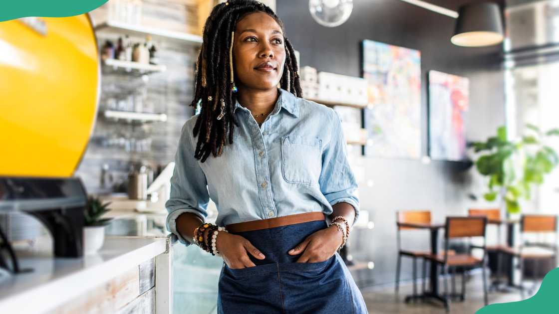 A coffeeshop manager looks on