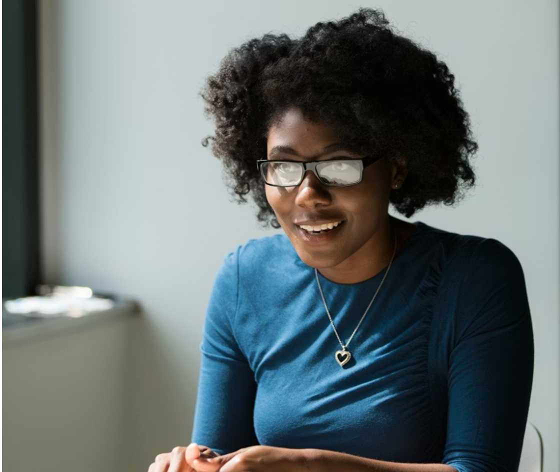 Attentive woman listening to her colleague in the office Attentive woman listening to her colleague in the office