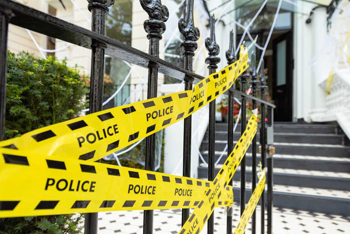 Police secure a mansion gate after an arrest. Police secure a mansion gate after an arrest.