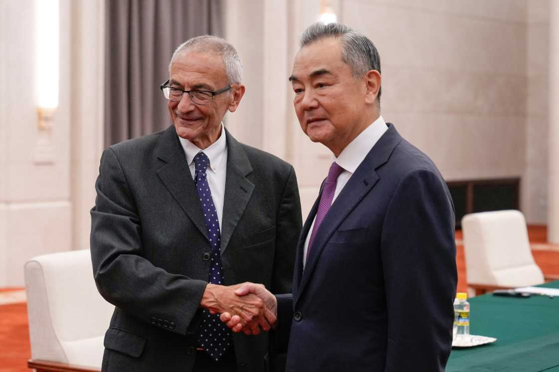 US White House senior adviser and climate envoy John Podesta (L) shakes hands with China's Foreign Minister Wang Yi at the Great Hall of the People in Beijing on September 6, 2024. US White House senior adviser and climate envoy John Podesta (L) shakes hands with China's Foreign Minister Wang Yi at the Great Hall of the People in Beijing on September 6, 2024.