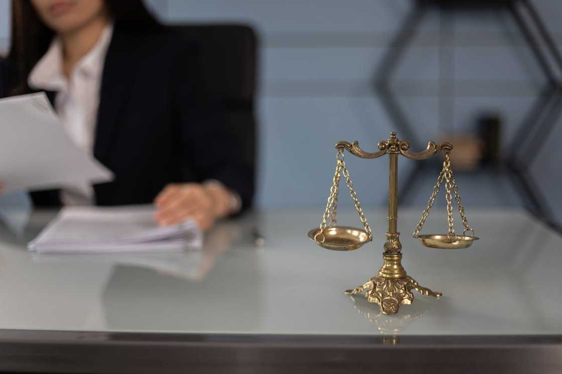 A set of balance scales sits on a desk in a lawyers' office.