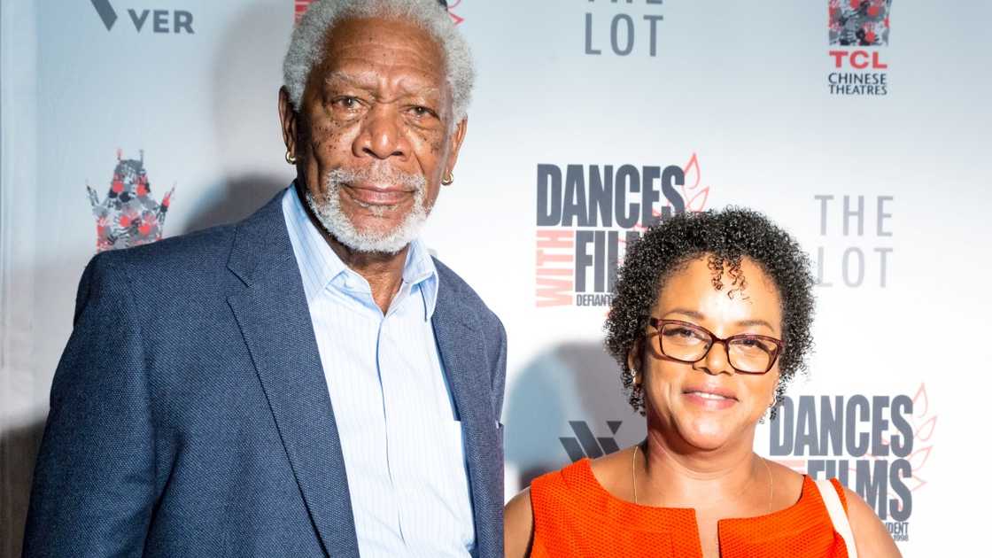 Morgan Freeman, in a blue suit, and Deena Adair, in a red dress, were pictured at the premiere of Landing Up.