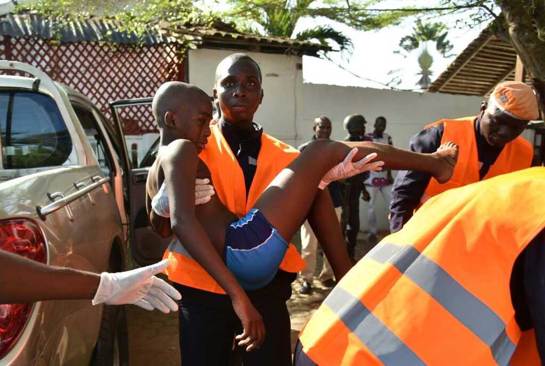A rescue worker carries a young boy who was wounded in the attack A rescue worker carries a young boy who was wounded in the attack