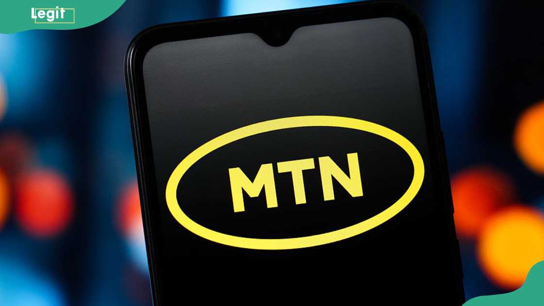 A smartphone screen displays the MTN logo against a blurred, colorful city backdrop. A smartphone screen displays the MTN logo against a blurred, colorful city backdrop.