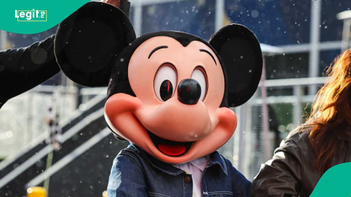 Lady who is scared of Mickey Mouse runs from a party. Lady who is scared of Mickey Mouse runs from a party.