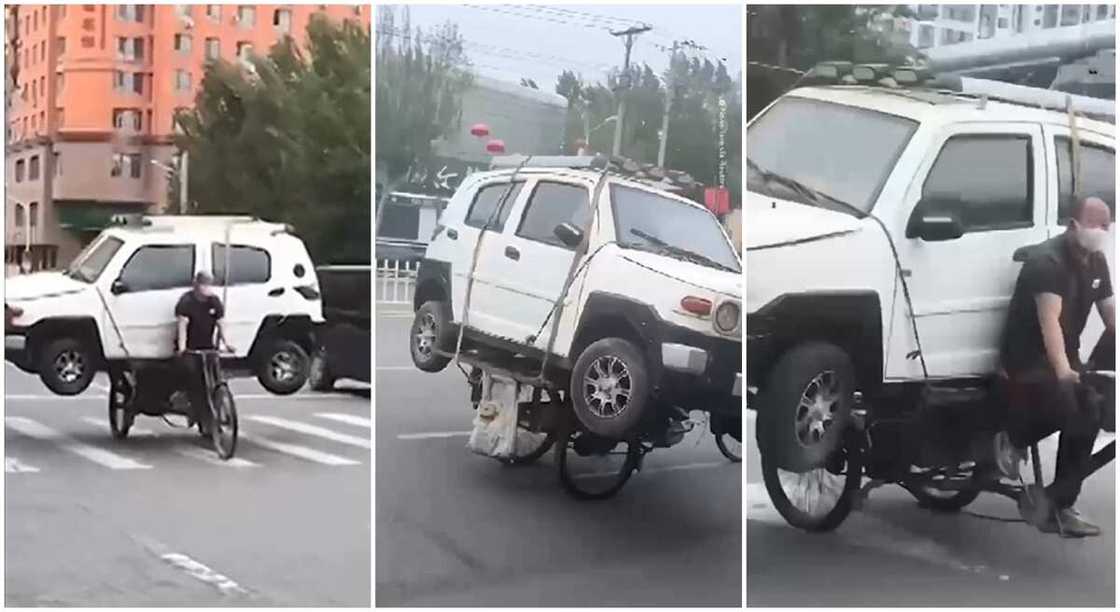 Chinese man uses bike to carry a car in video. Chinese man uses bike to carry a car in video.