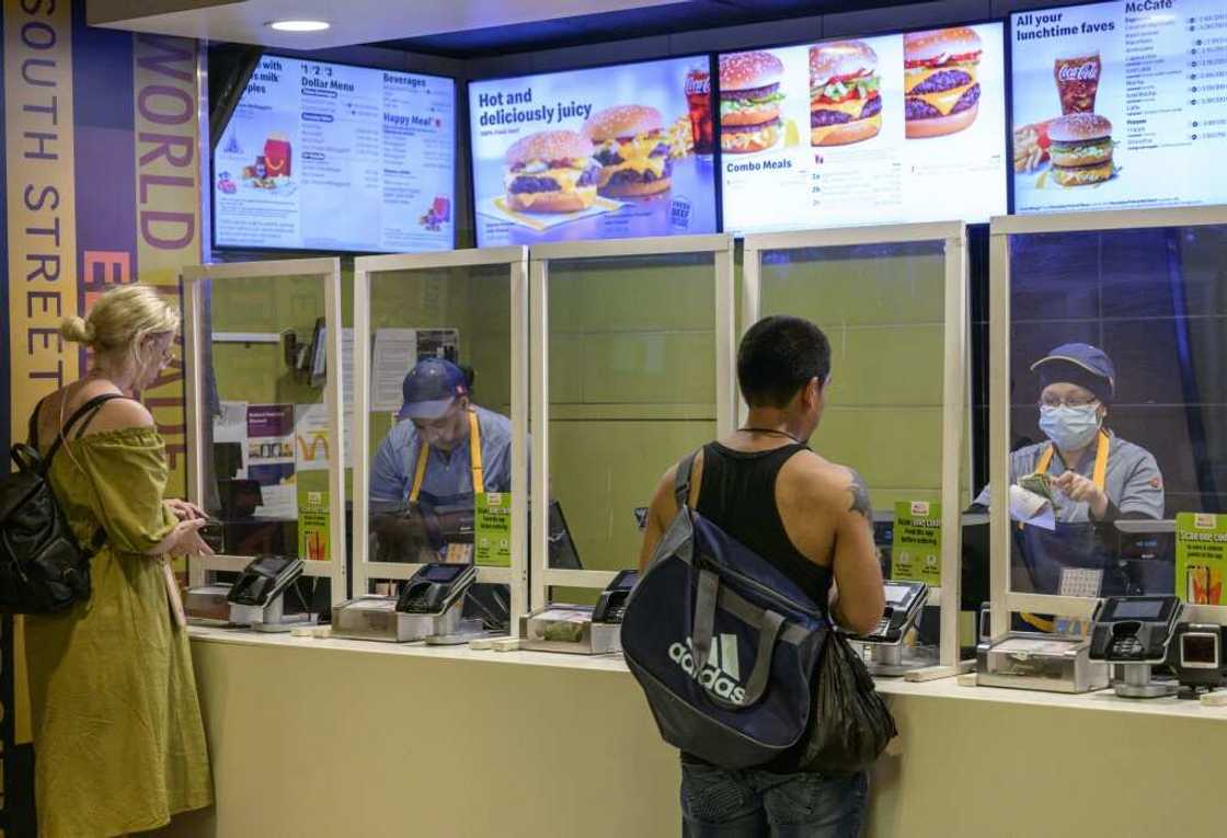Service sector employees, like these McDonald's workers pictured in New York in May 2022, earn less than the average American Service sector employees, like these McDonald's workers pictured in New York in May 2022, earn less than the average American