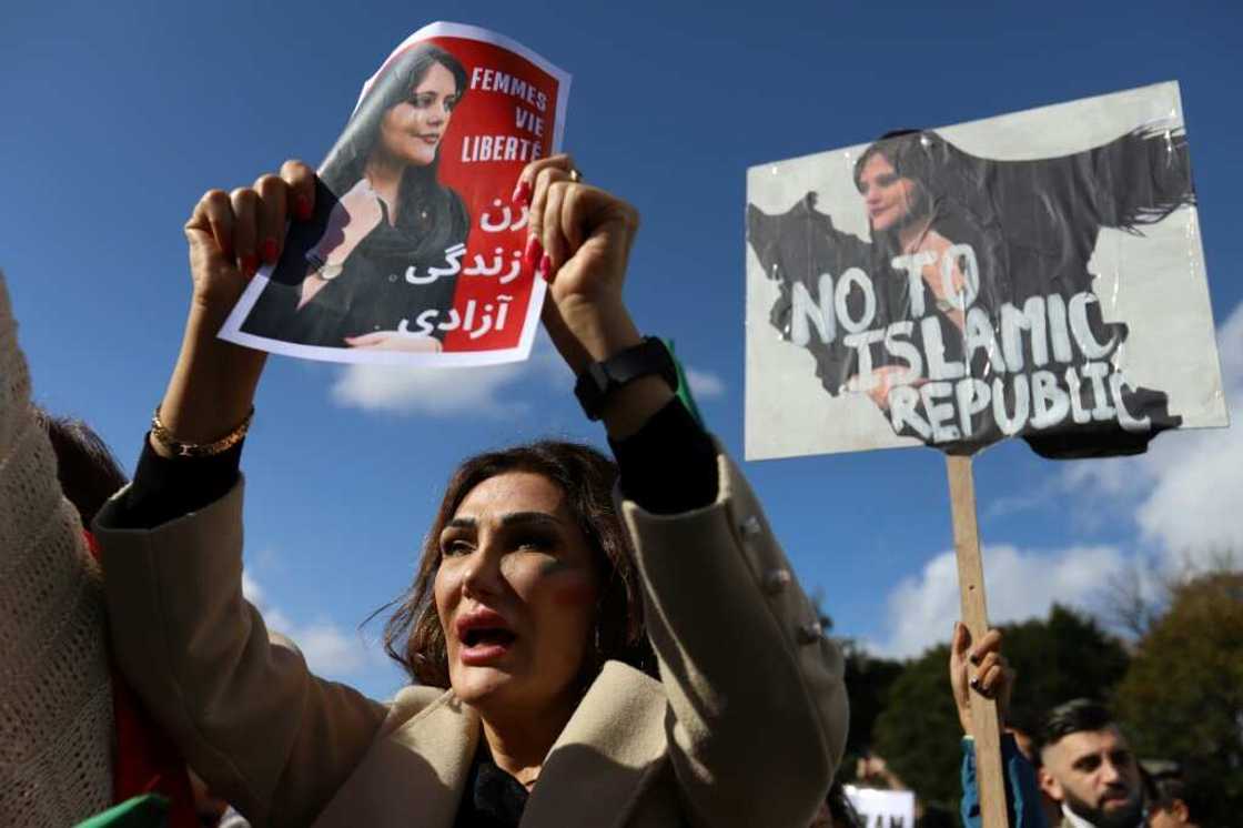 A protestor holds a portrait of Mahsa Amini during a demonstration in Brussels on October 1, 2022 A protestor holds a portrait of Mahsa Amini during a demonstration in Brussels on October 1, 2022