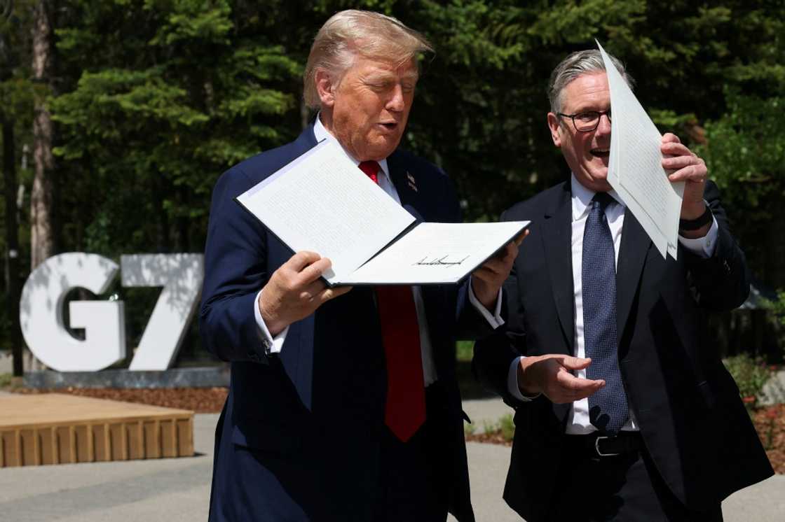 US President Donald Trump holds a signed US-UK trade deal next to British Prime Minister Keir Starmer US President Donald Trump holds a signed US-UK trade deal next to British Prime Minister Keir Starmer