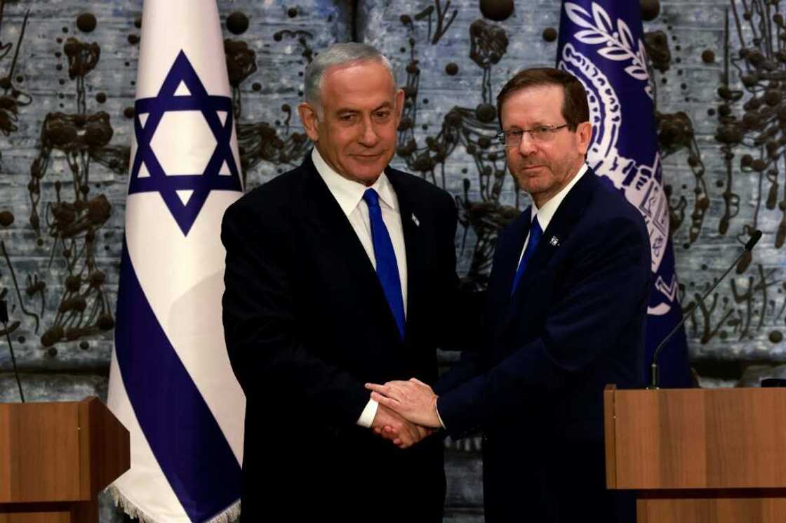 Israeli ex-premier Benjamin Netanyahu, on the left, was mandated with forming a new government by President Isaac Herzog Israeli ex-premier Benjamin Netanyahu, on the left, was mandated with forming a new government by President Isaac Herzog