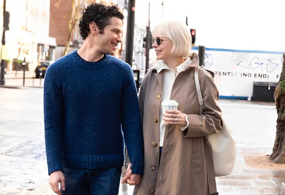 Michelle Williams walking in London while holding hands with Thomas Kail. Michelle Williams walking in London while holding hands with Thomas Kail.