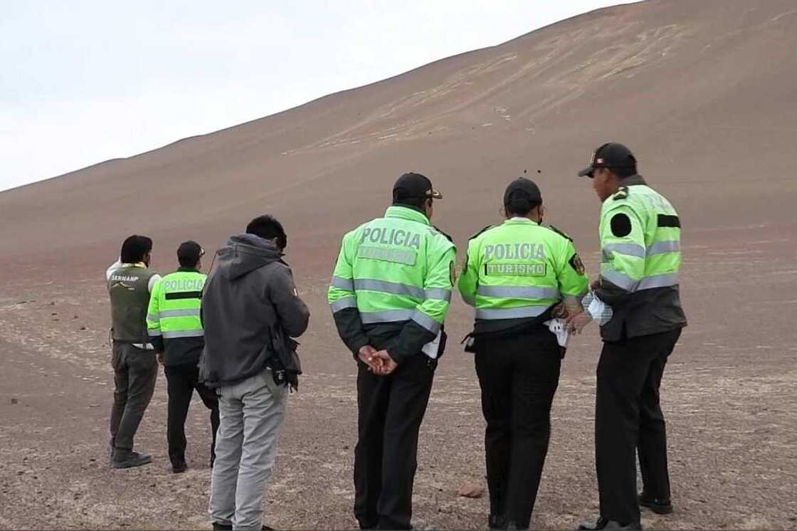 A frame grab from a video courtesy of the Peruvian Ministry of Culture shows police examining the damage at the Paracas Candelabra A frame grab from a video courtesy of the Peruvian Ministry of Culture shows police examining the damage at the Paracas Candelabra