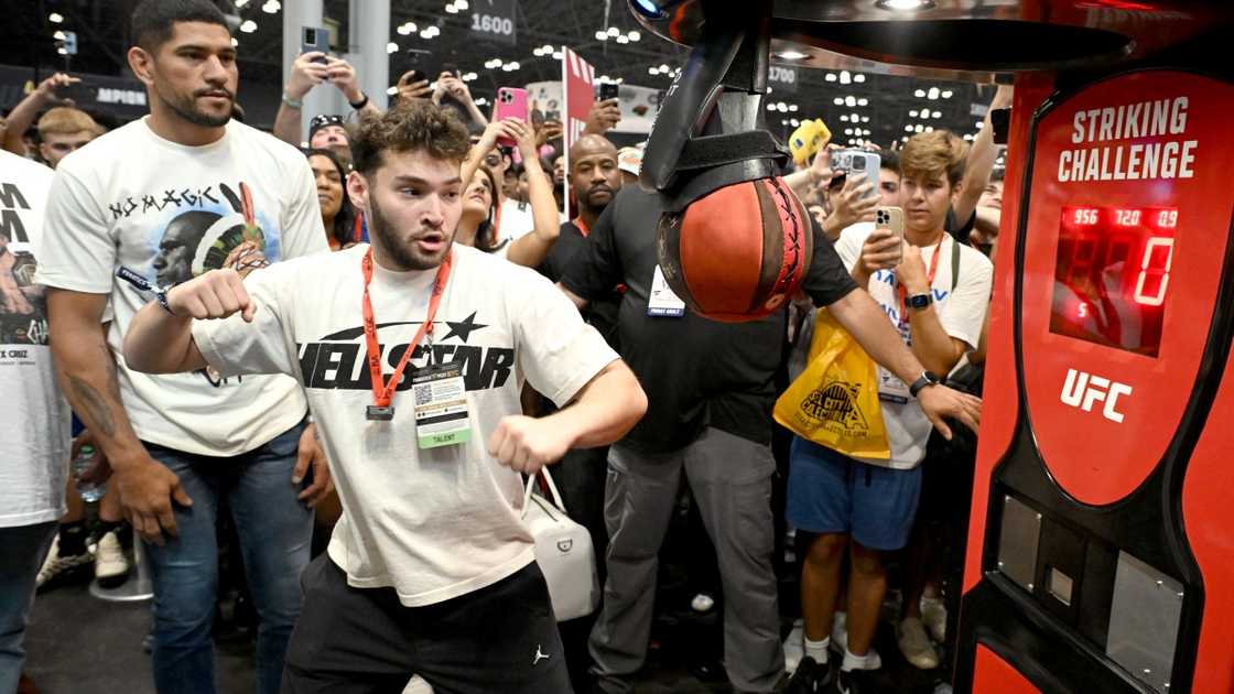 Adin Ross throws a punch during a striking challenge.