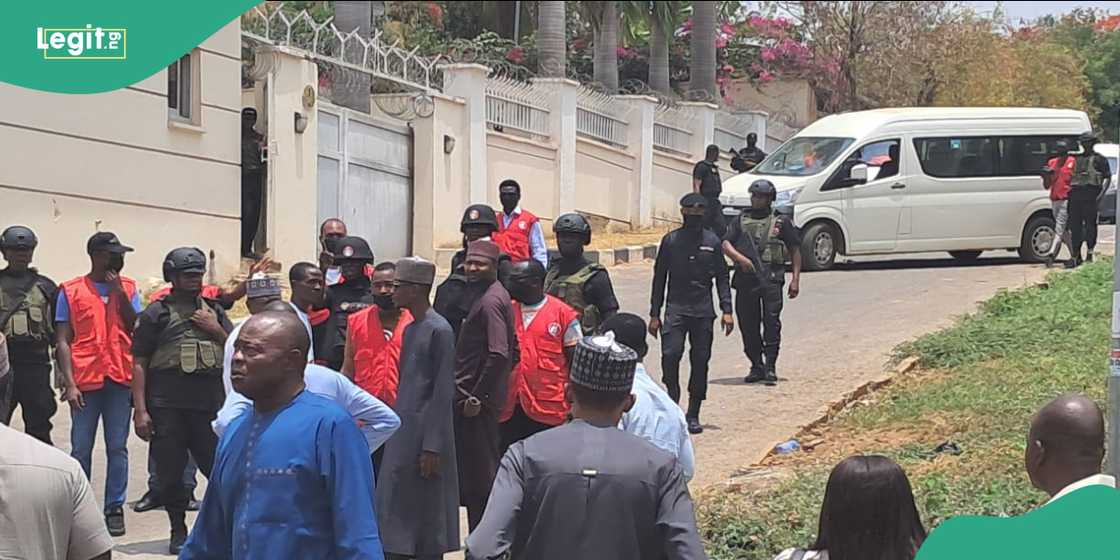 EFCC officers arrived at the location in multiple buses during the operation. EFCC officers arrived at the location in multiple buses during the operation.