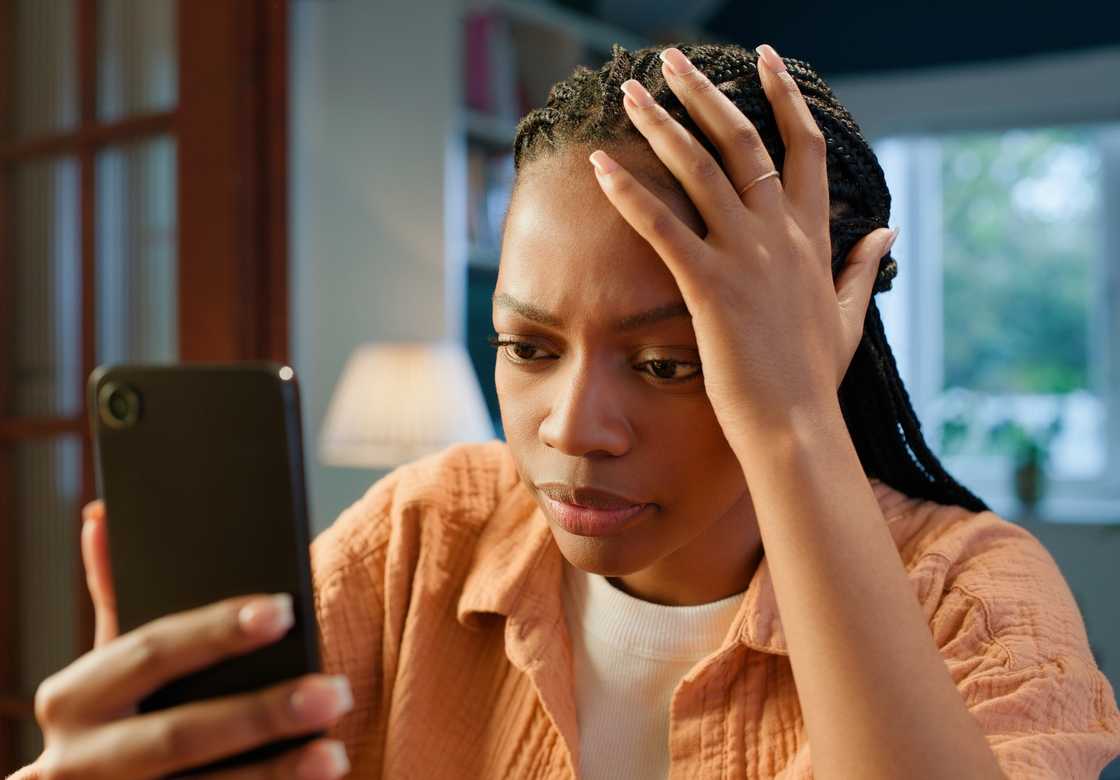A woman reading a text on a phone A woman reading a text on a phone