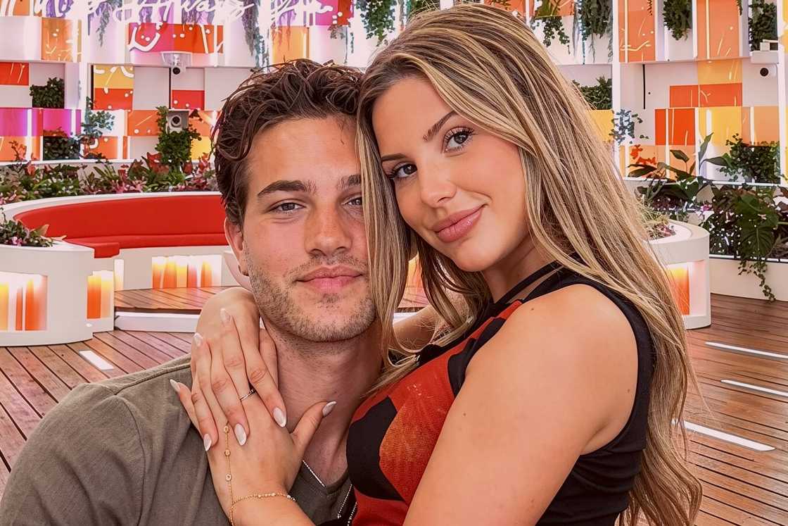 Iris Kendall sits on TJ Palma's lap in a pose Iris Kendall sits on TJ Palma's lap in a pose