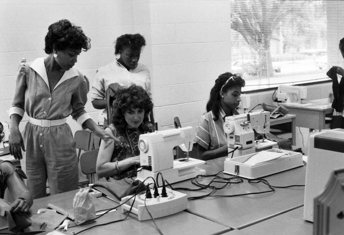 Faculty member demonstrating sewing techniques to students on campus at Prairie View A&M University Faculty member demonstrating sewing techniques to students on campus at Prairie View A&M University