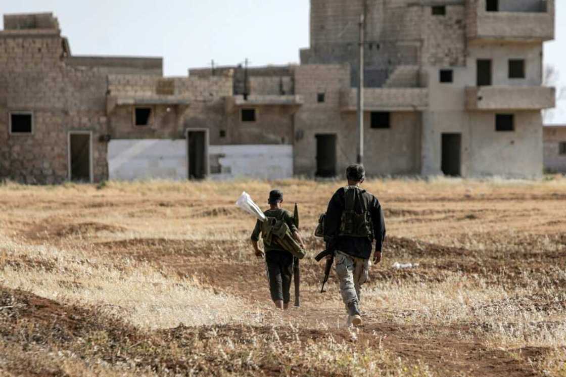Turkish-backed Syrian rebel fighters are seen near the front lines with the Syrian Democratic Forces (SDF) in the countryside of Syria's northern city of Manbij, on June 8, 2022. Erdogan has threatened to launch a new offensive in northern Syria Turkish-backed Syrian rebel fighters are seen near the front lines with the Syrian Democratic Forces (SDF) in the countryside of Syria's northern city of Manbij, on June 8, 2022. Erdogan has threatened to launch a new offensive in northern Syria