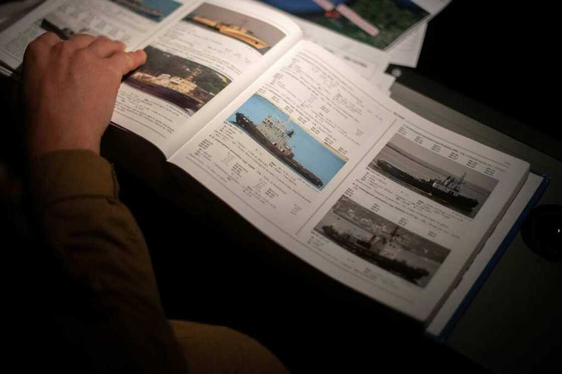 Reference books help identify ships observed from the sky Reference books help identify ships observed from the sky