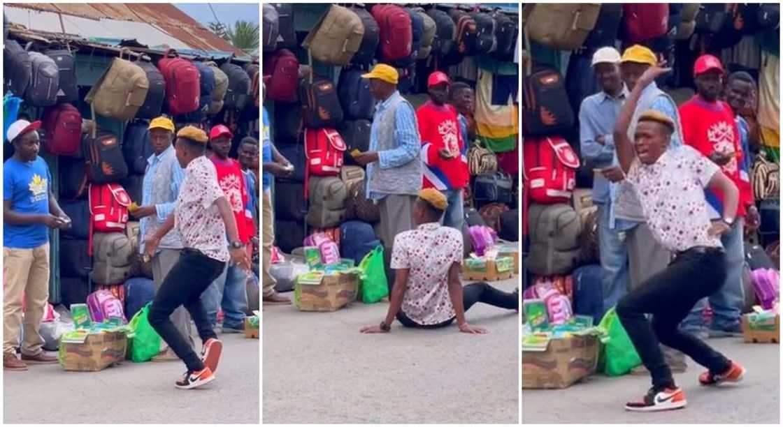 Photo of tall man dancing inside an African market.