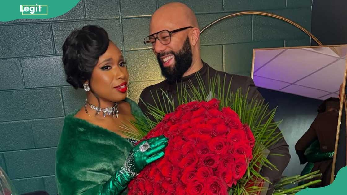 Rapper Common presents a bouquet of flowers to Jennifer Hudson