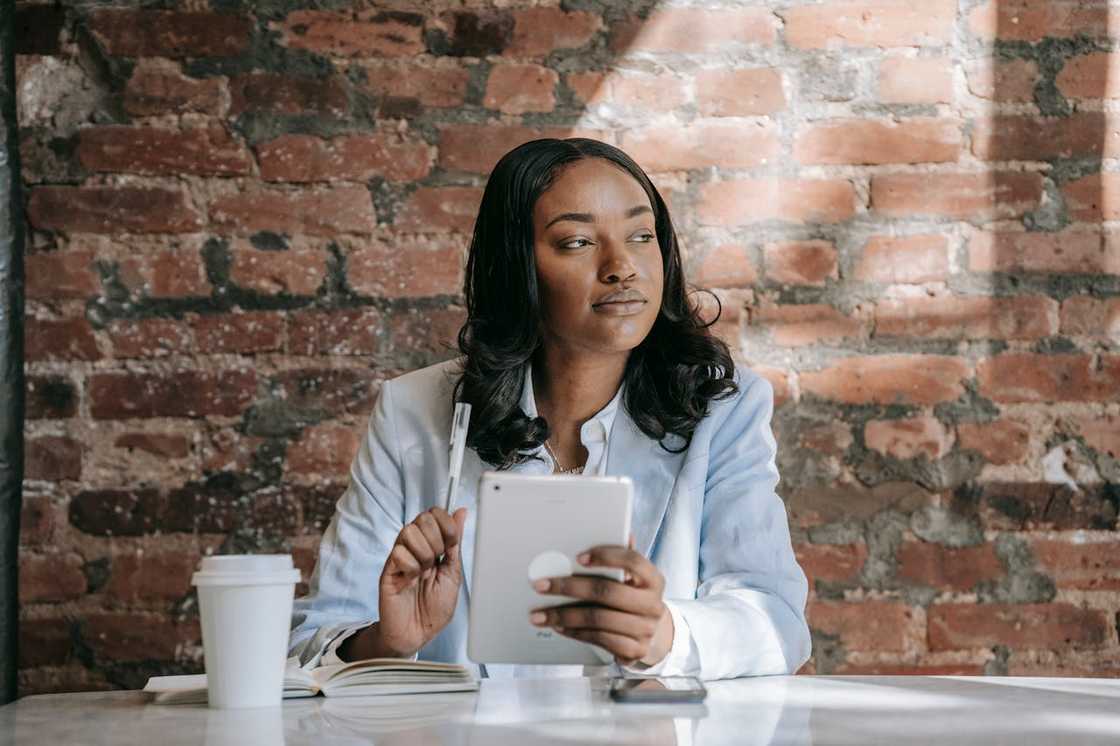 A woman sits alone in a table at a café.