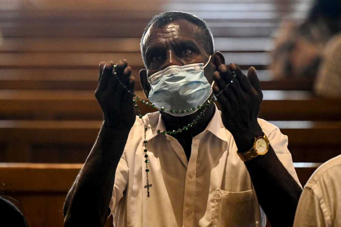 A man prays during a service at St. Anthony's church in Colombo