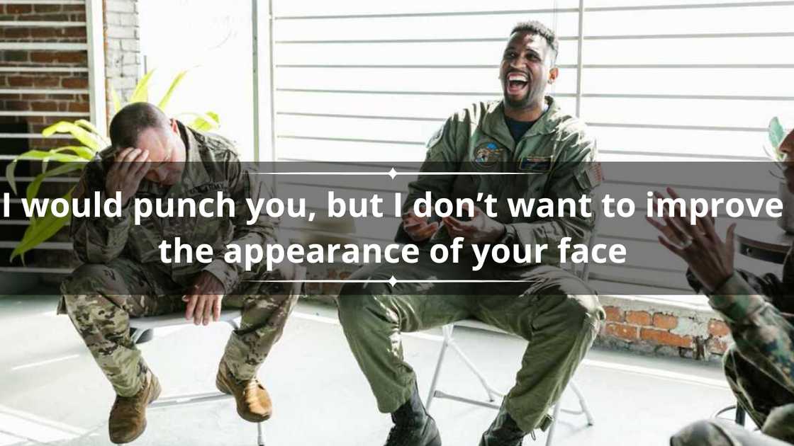 Three men in military uniform sitting down while enjoying a joke at the expense of one of them Three men in military uniform sitting down while enjoying a joke at the expense of one of them