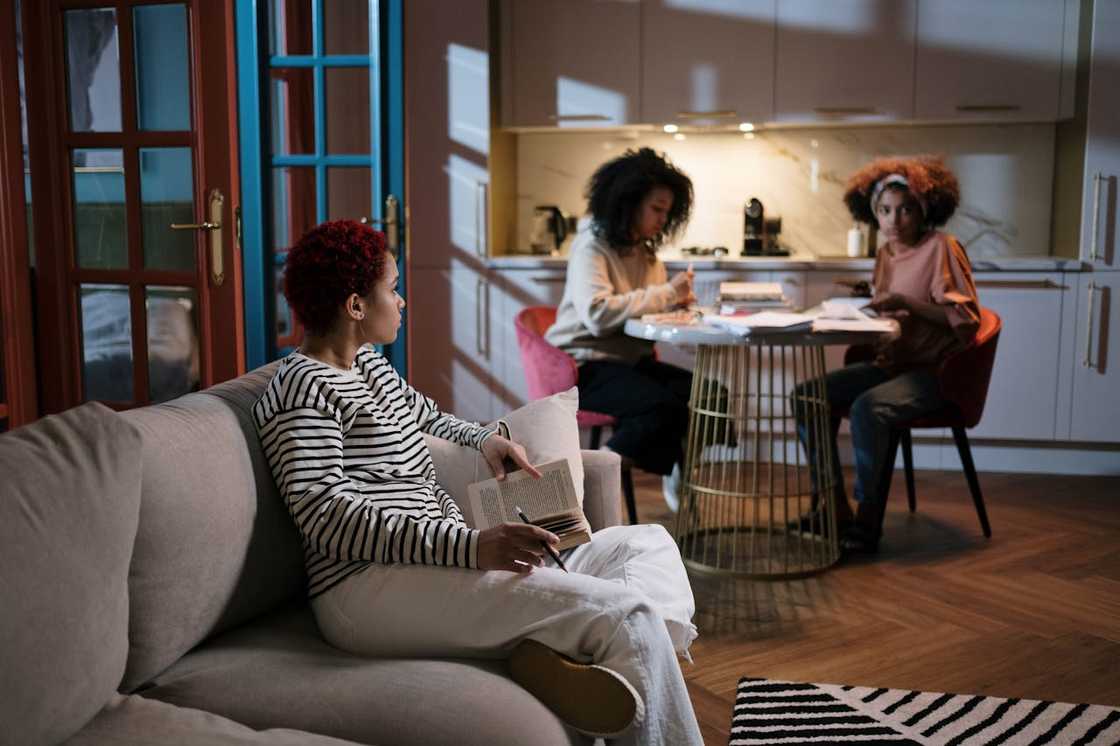 A group of young women sitting in a modern apartment during a retreat session. A group of young women sitting in a modern apartment during a retreat session.