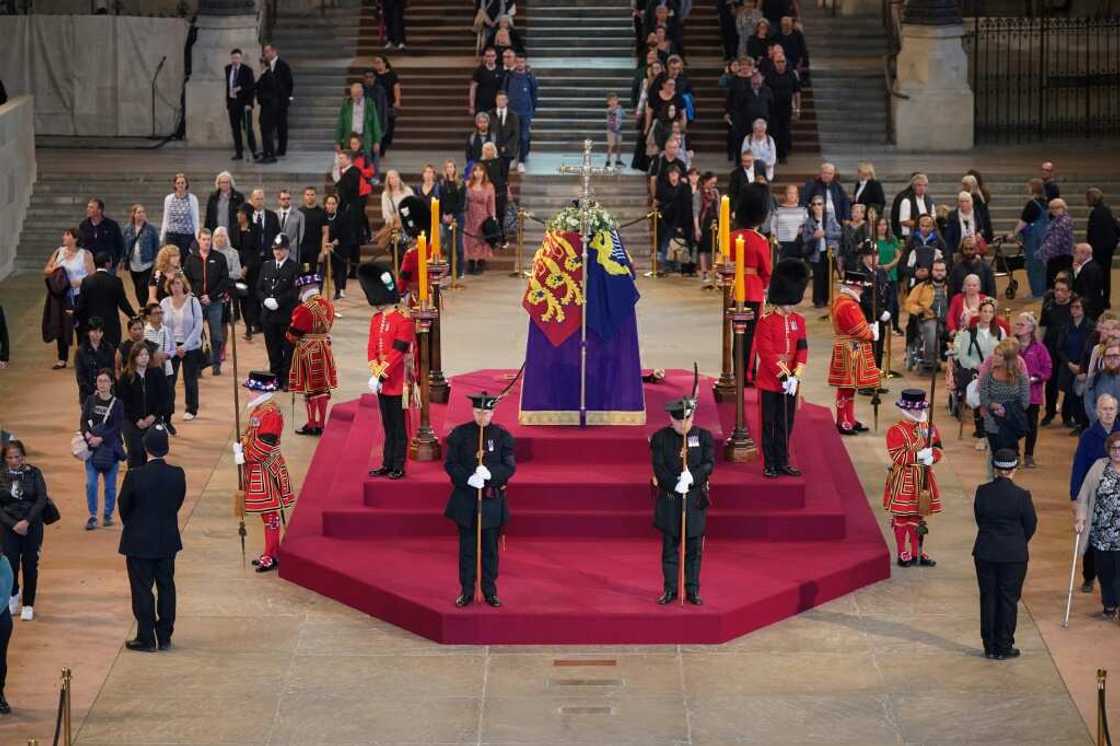 Mourners have marked their moment in front of the coffin in various ways, from bows or curtsies to the sign of the cross or by simply removing their hats