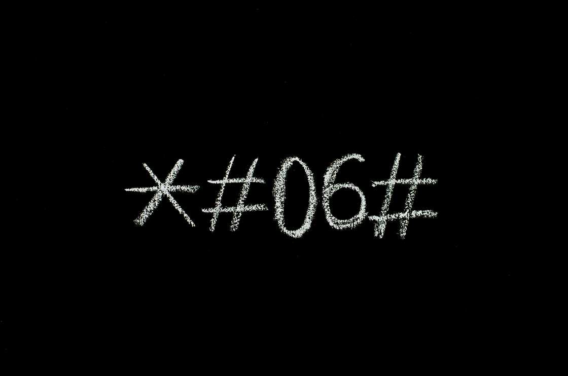 IMEI code written on a black surface IMEI code written on a black surface