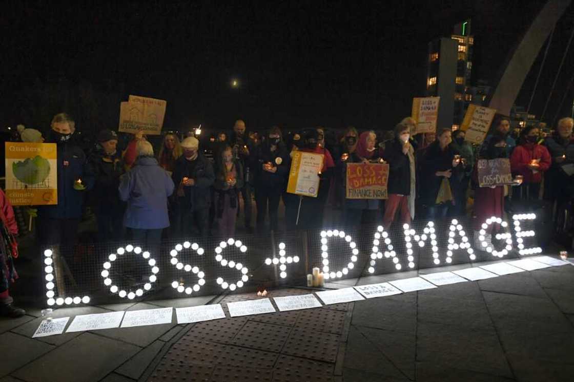 Climate activists holding a vigil for people around the world experiencing the most severe climate impacts during the UN COP26 conference in Glasgow