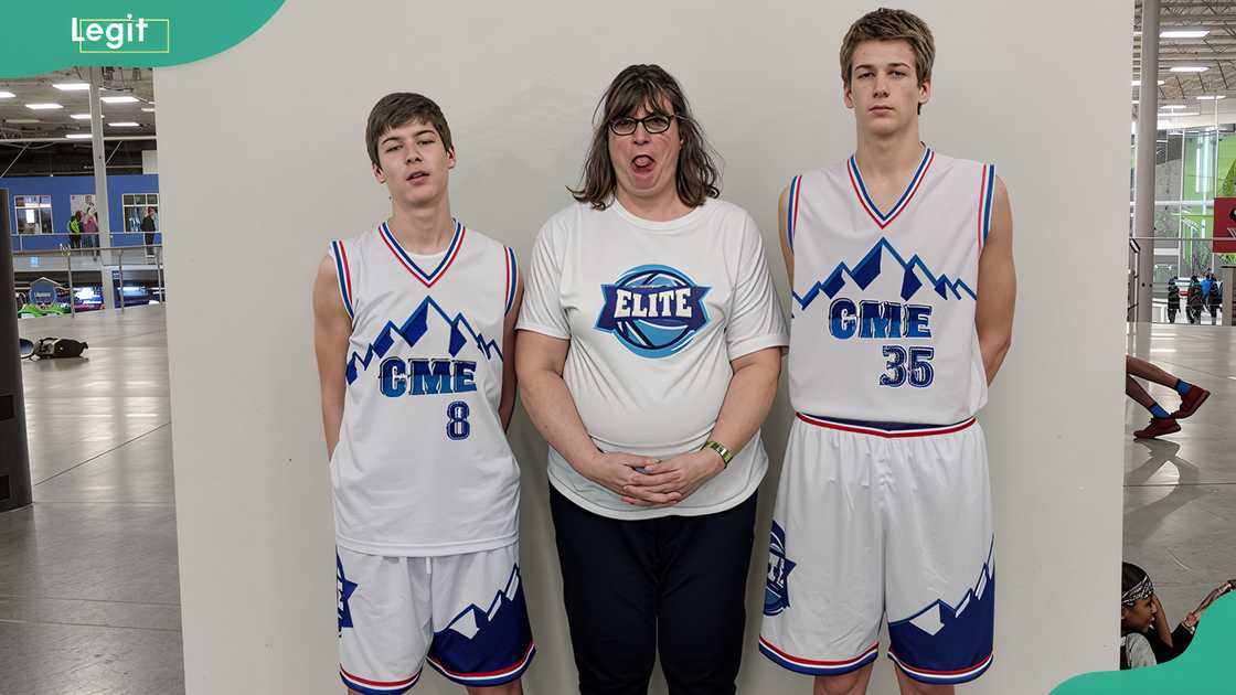 Kyle Filipowski, his mom, and brother posing for a photo after a basketball game Kyle Filipowski, his mom, and brother posing for a photo after a basketball game