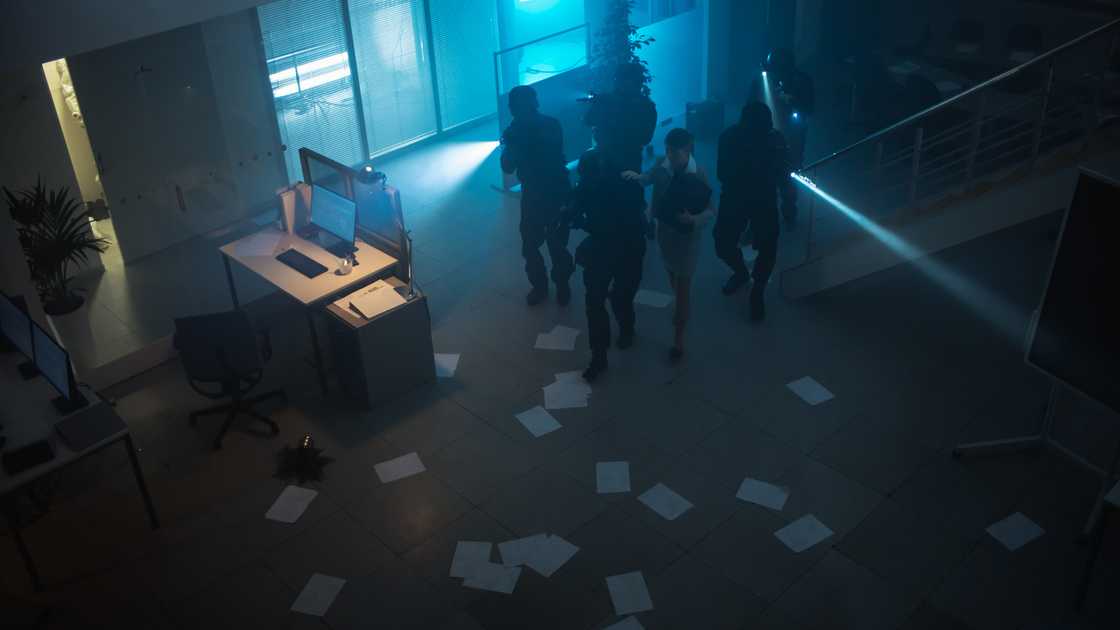 Police enter a Lagos office as a businessman freezes in place. Police enter a Lagos office as a businessman freezes in place.