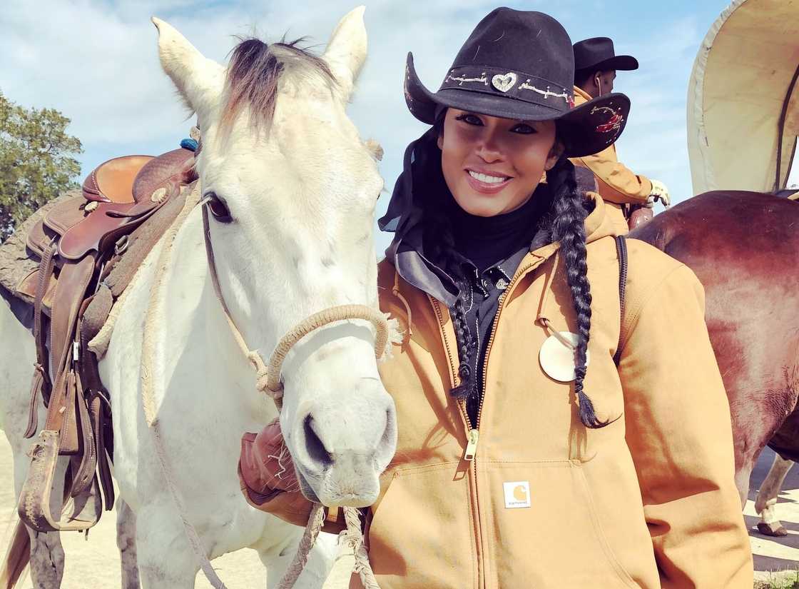 Pilar Sanders poses with a horse