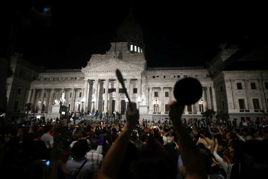 People bang pans and pots during a demonstration against the new government of Argentine President Javier Milei in front of the National Congress