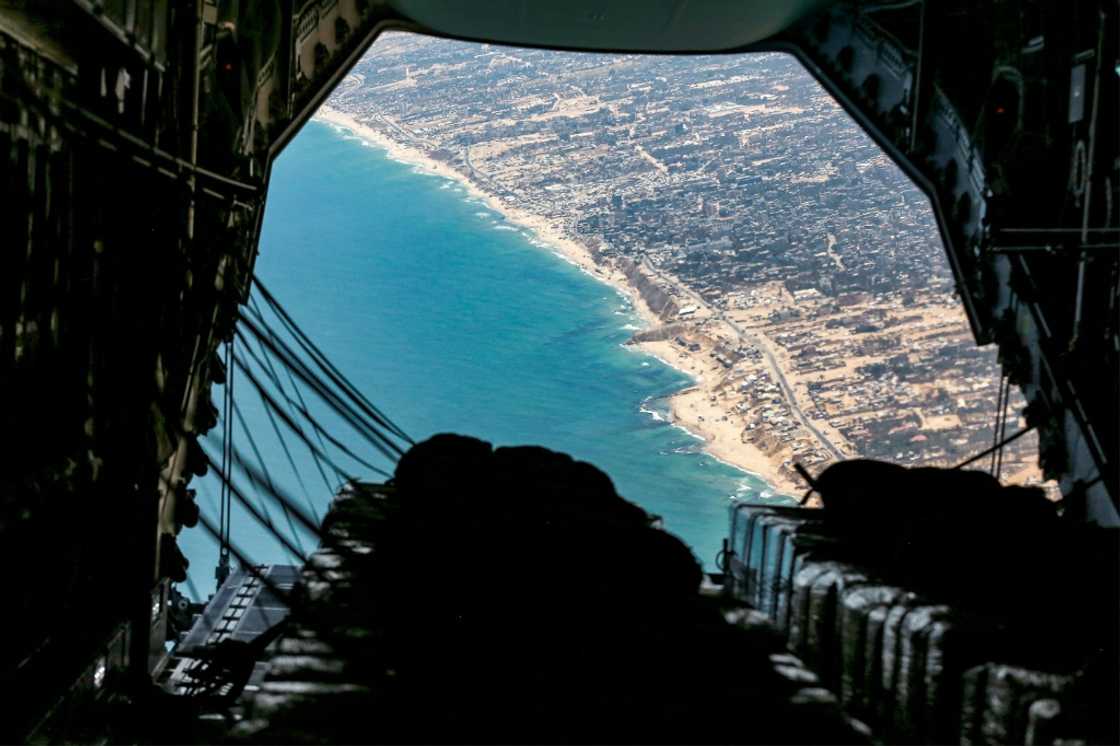 The cargo ramp of a German Air Force (Luftwaffe) A400M Atlas military transport aircraft is opened before releasing humanitarian aid pallets during an airdrop relief mission over the Gaza Strip on August 5, 2025