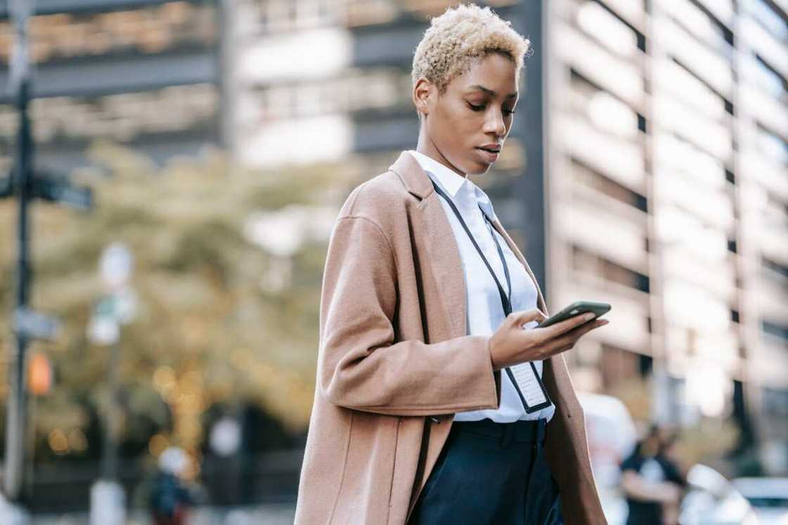 A lady dialing a phone