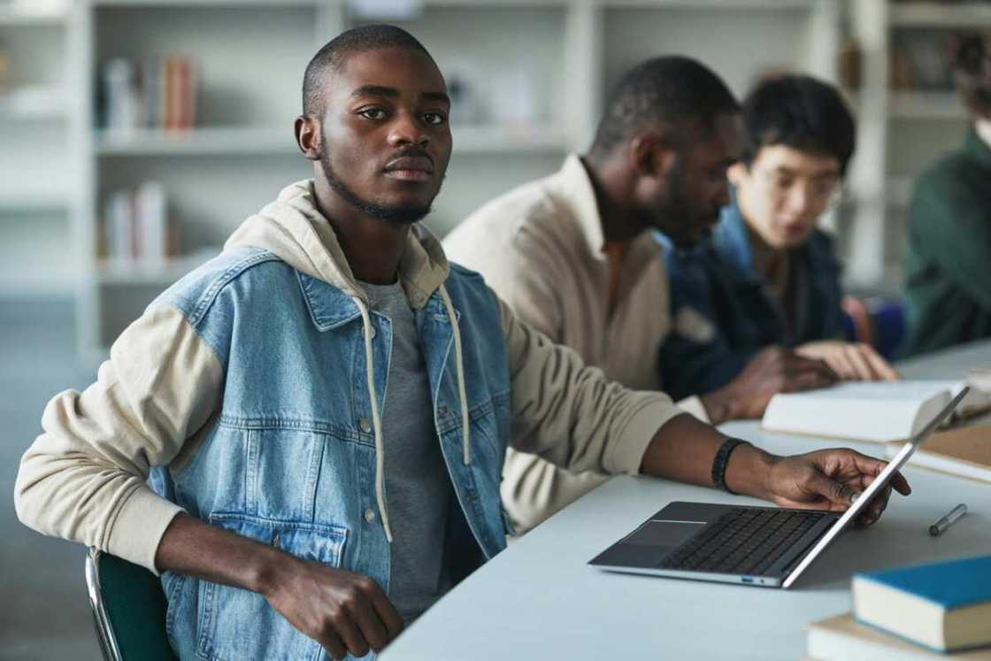 A male student using a laptop A male student using a laptop