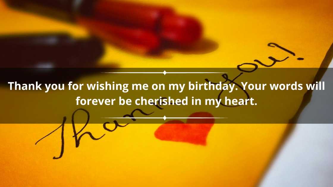 A heart and the words thank you on a yellow card A heart and the words thank you on a yellow card