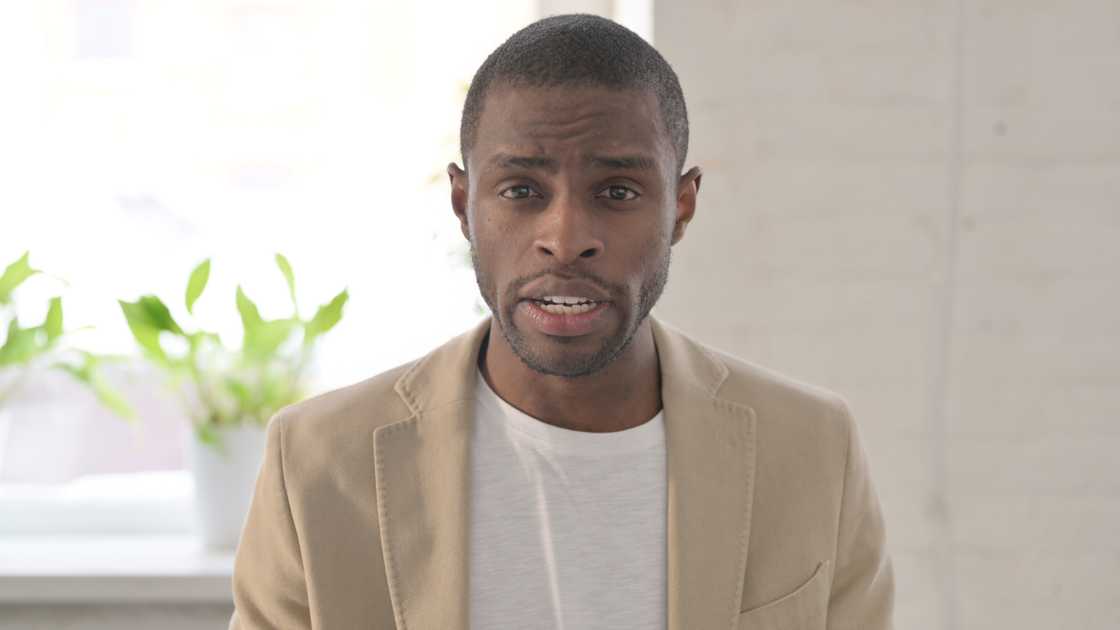 A Young man talking while looking at the camera A Young man talking while looking at the camera