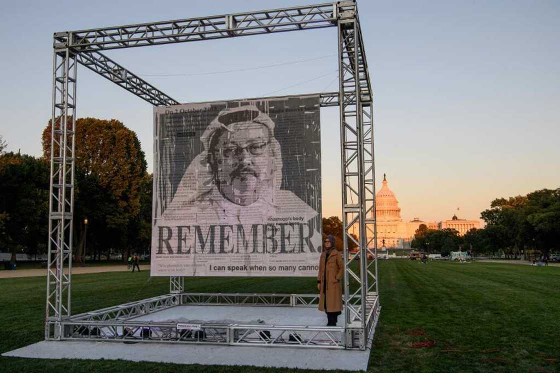 Turkish writer Hatice Cengiz, fiancee of Saudi journalist Jamal Khashoggi, poses next to his portrait in Washington on October 1, 2021, on the third anniversary of his murder at the Saudi consulate in Istanbul