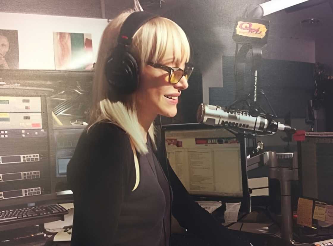 Carol Miller broadcasting from the Q104.3 (WAXQ-FM) studios.