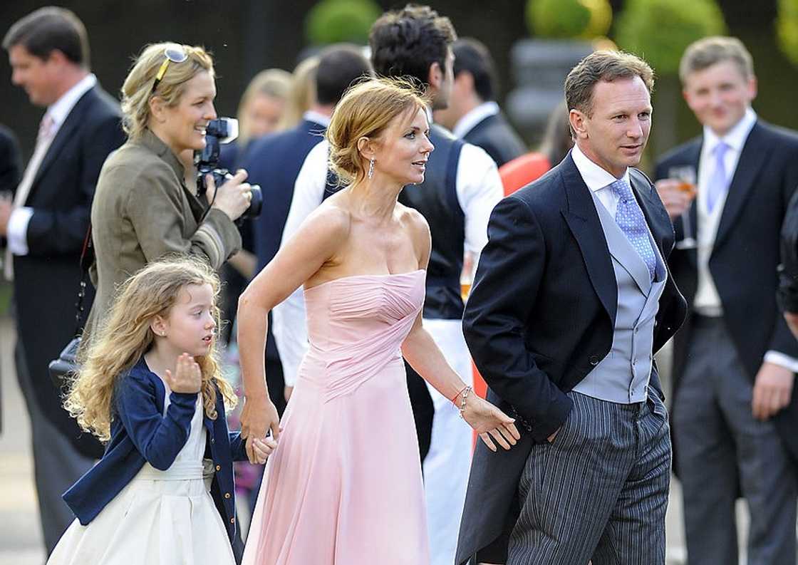 Geri Halliwell (L) holding Bluebell Halliwell hand (C) and Christian Horner (R) walking at Kensington Palace Gardens