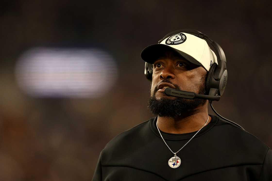 Mike Tomlin pictured in a dark outfit during a football game. Mike Tomlin pictured in a dark outfit during a football game.