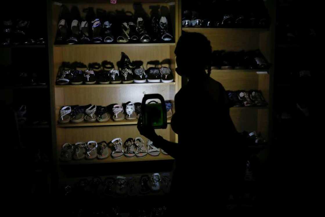 Shopping by torchlit: Rolling blackouts have inflicted wrenching change on life for many South Africans Shopping by torchlit: Rolling blackouts have inflicted wrenching change on life for many South Africans