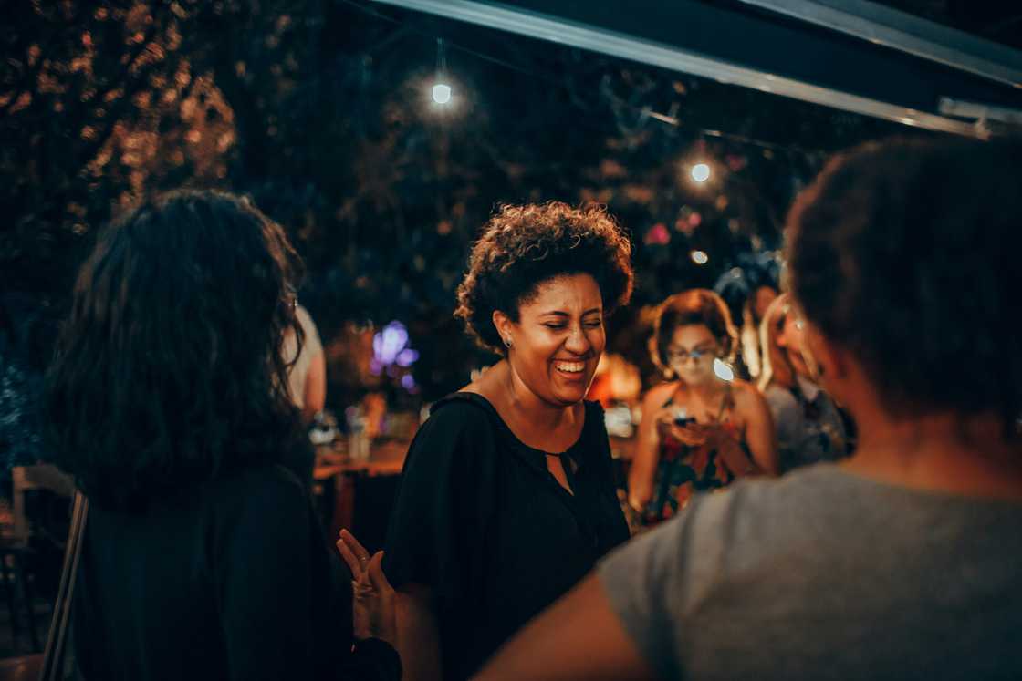 A group of women laughing in a club A group of women laughing in a club