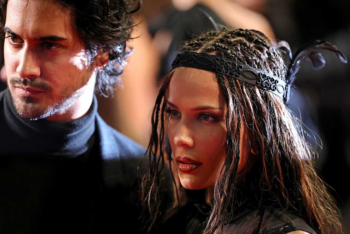 A close-up of a man and woman standing side by side, the woman wearing a braided headpiece. A close-up of a man and woman standing side by side, the woman wearing a braided headpiece.